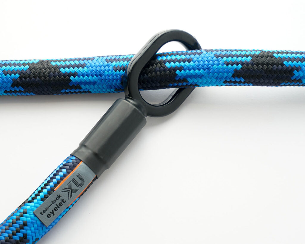 blue and black patterned textile rope through one of the two rubberised metal loops of the tex–lock eyelet