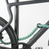Small U-lock with extension made of colorful textile secures front and rear wheel at the same time on the bike stand