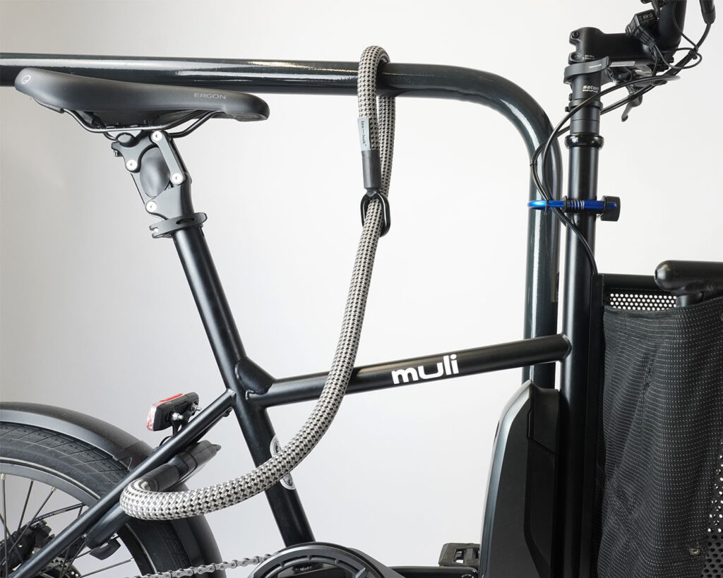 Frame lock with textile extension in gray-black secures e-bike to bike stand